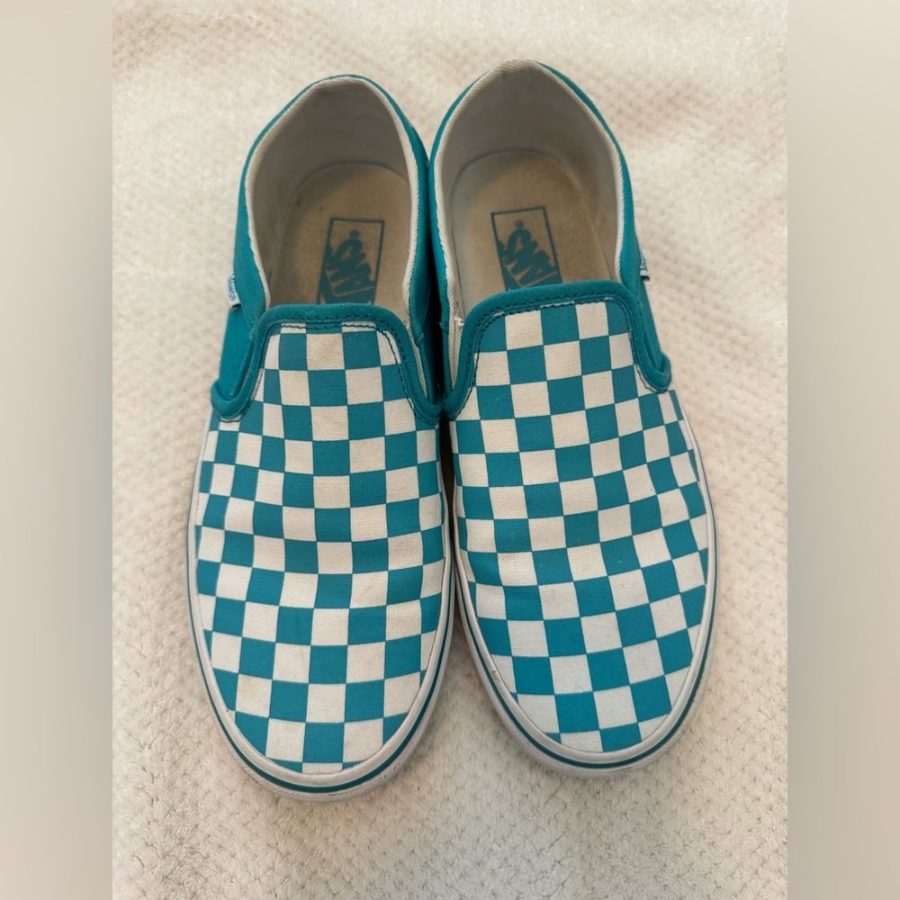 Teal checkerboard Vans slip ons.